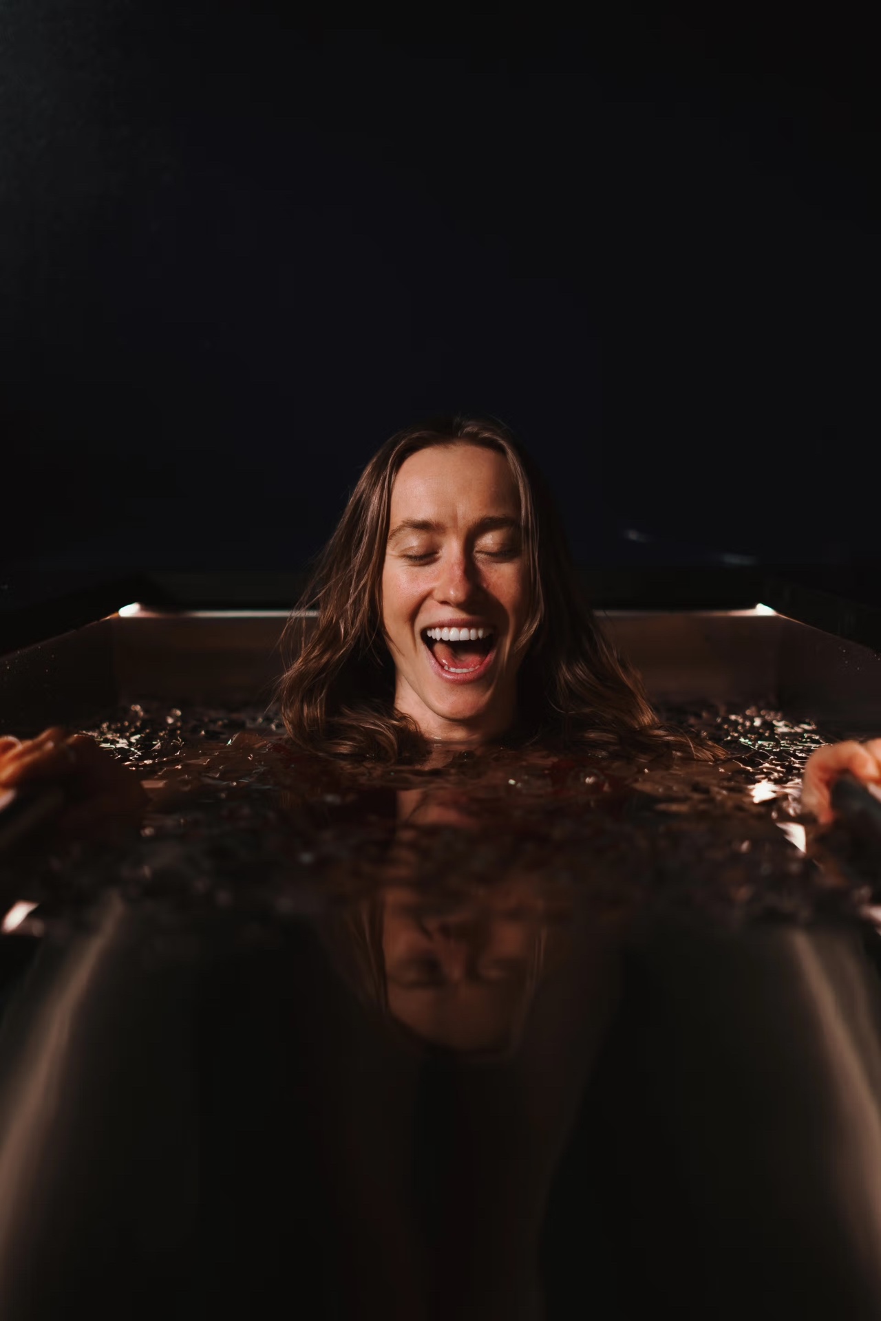 Woman experiencing ice bath at Arc Sauna