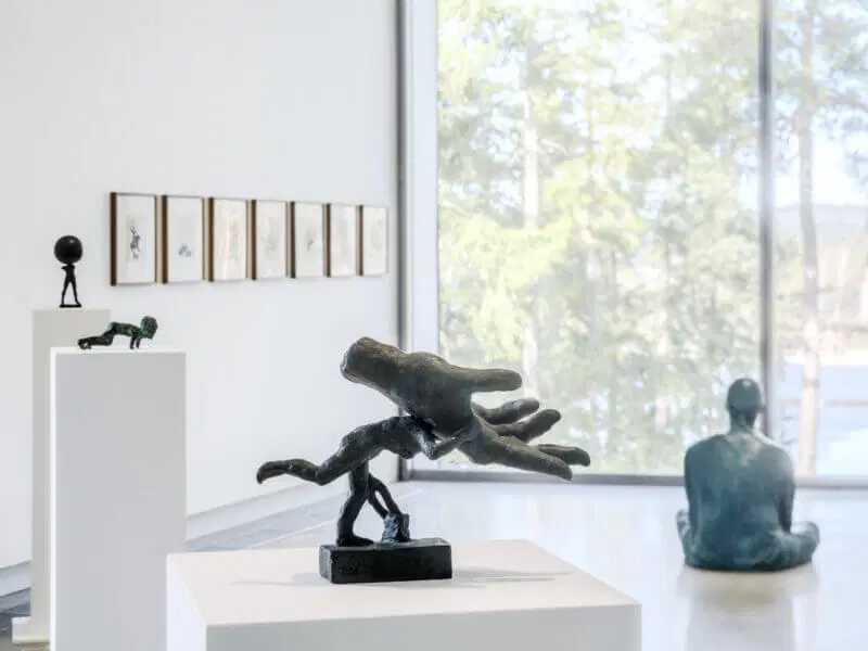 Artipelag — interior gallery space with sculptures and forest framed through floor-to-ceiling glass