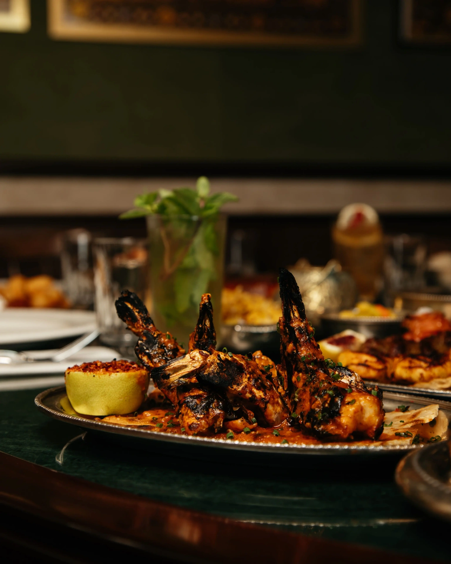Berenjak Doha — charcoal-grilled kebab platter with bone-in lamb chops, chilli salt-rimmed lemon and flatbread