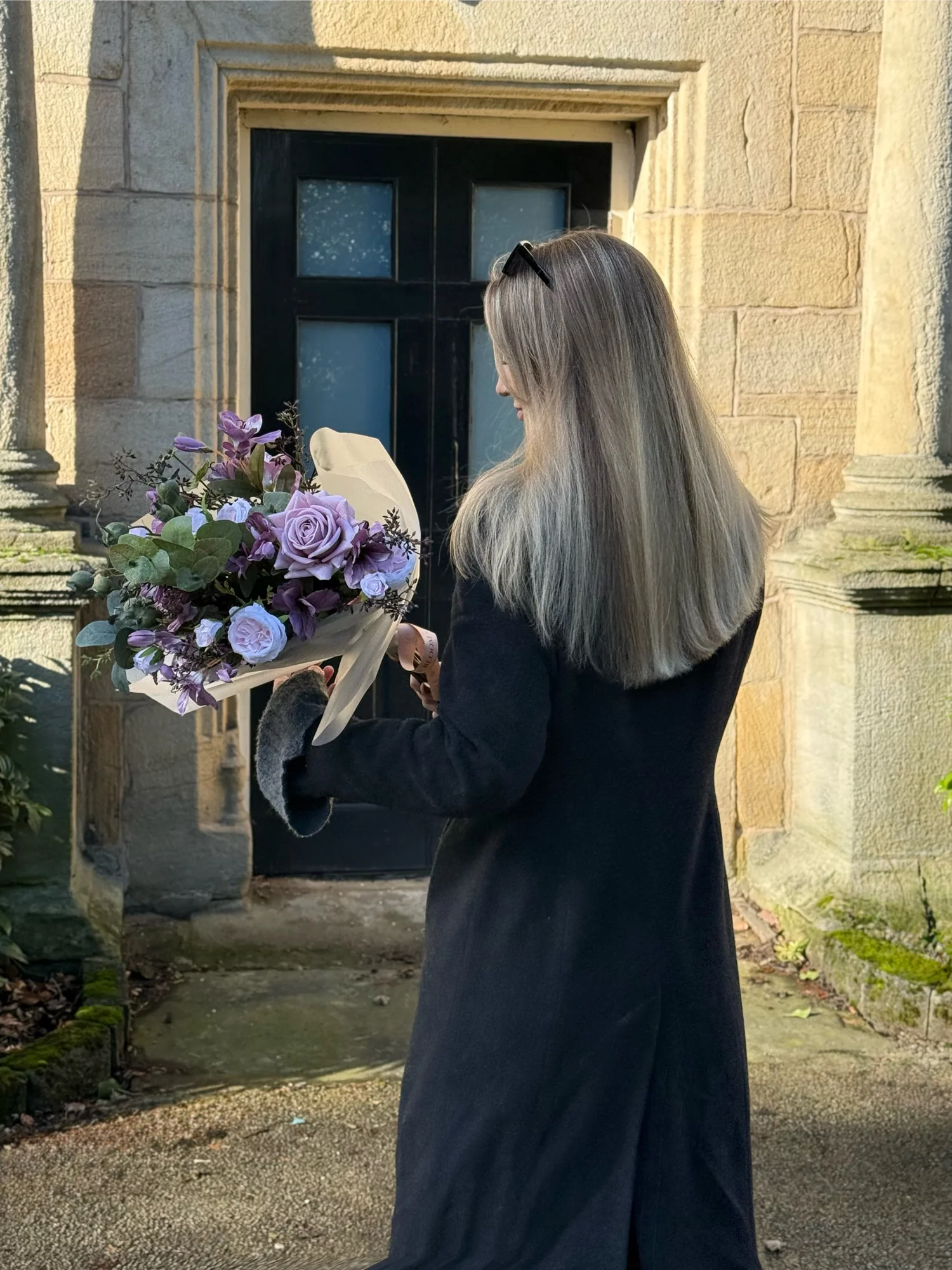 Michelle, founder of Best & Bloom, with arranged faux flowers