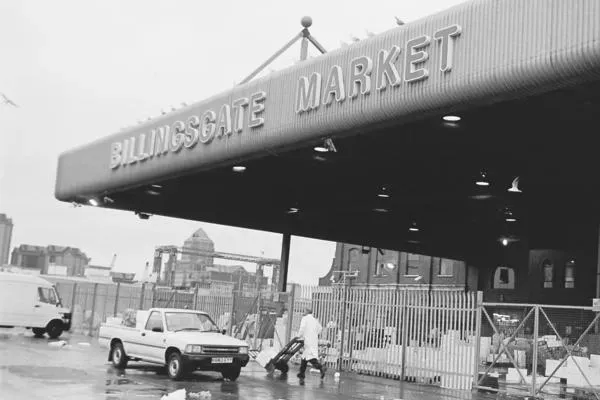 Billingsgate Market — the entrance canopy in black and white, the Isle of Dogs skyline behind