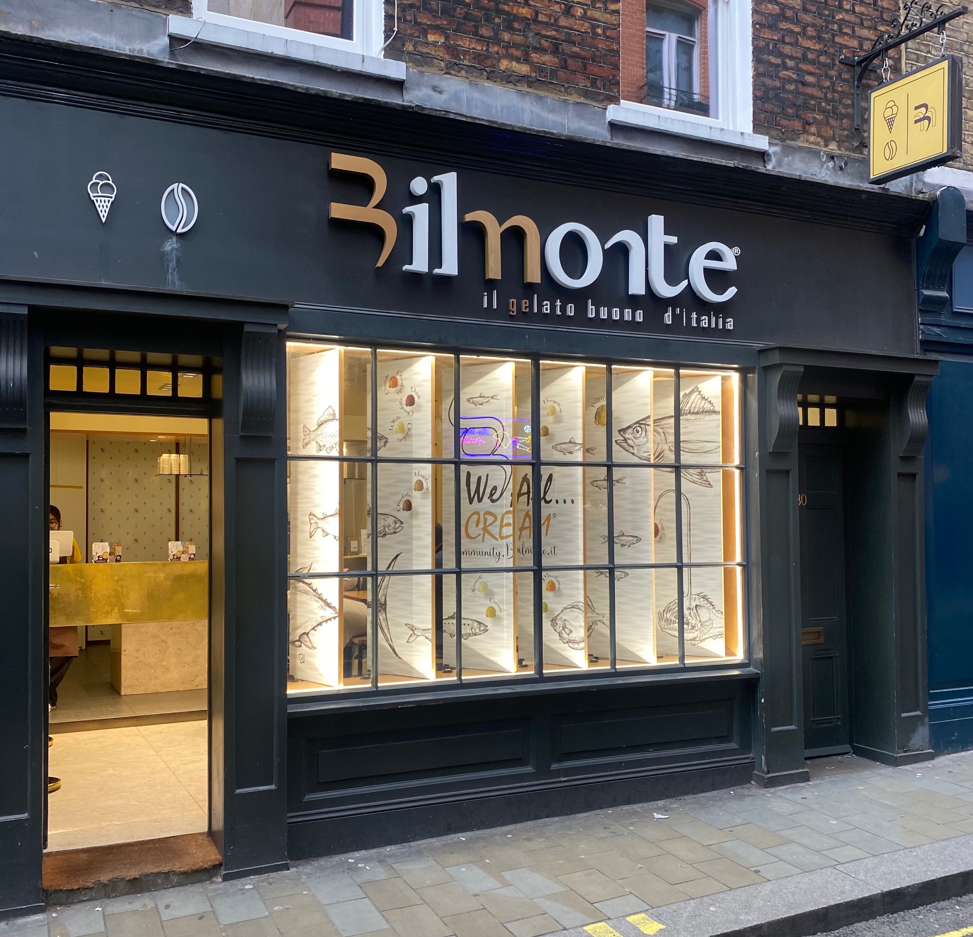 Bilmonte storefront in Soho with dark facade and warm interior lighting