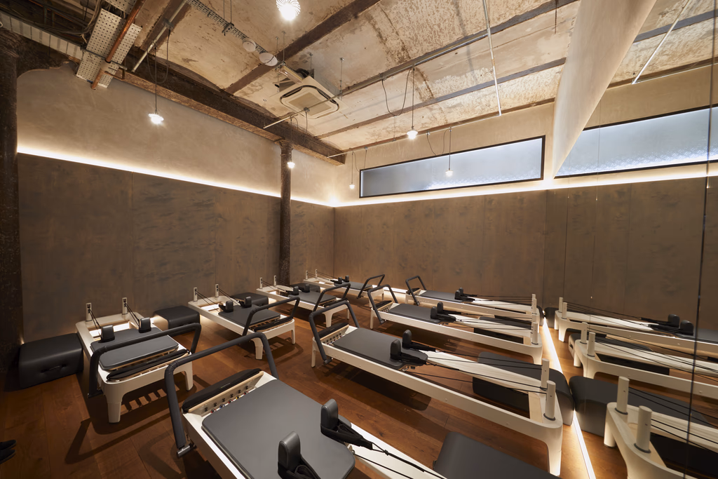 BLOK reformer Pilates studio with rows of reformer machines under warm lighting