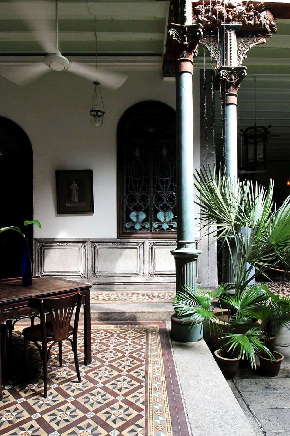 Tiled inner courtyard at the Cheong Fatt Tze Mansion, with columns and pitched roofs