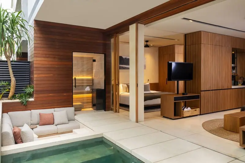 Open-plan living area with cedar sauna, plunge pool and timber joinery at Body Factory Lifestyle Residence Uluwatu