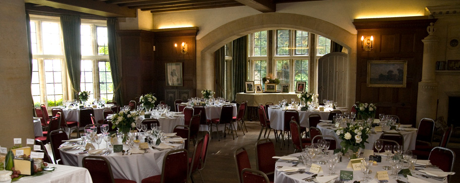 Chavenage House — panelled hall set for a private dinner with mullioned windows