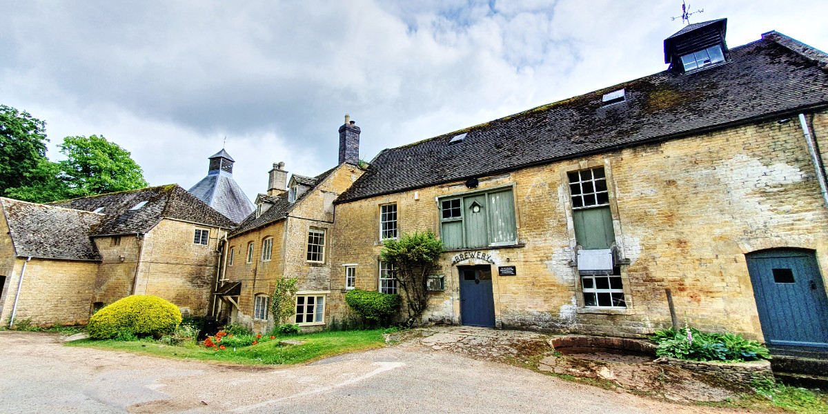 Donnington Brewery building exterior with Cotswold stone and brewery sign
