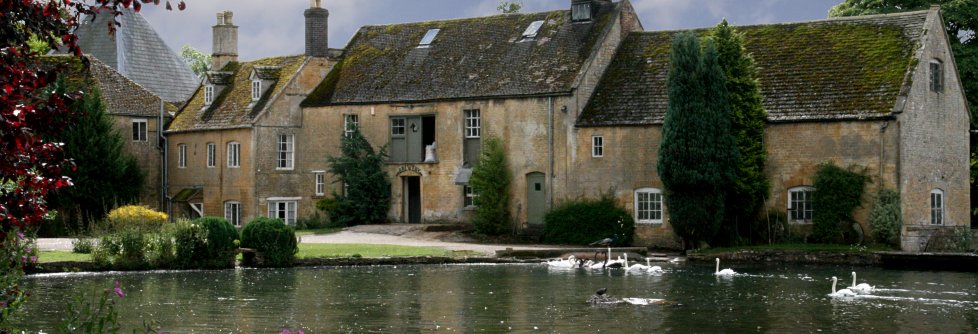 Swans on the mill pond at Donnington Brewery, Cotswolds