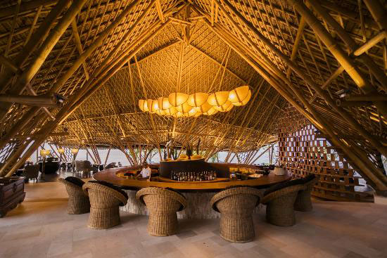 Dugong restaurant bar under a soaring bamboo dome with woven rattan stools and pendant lighting