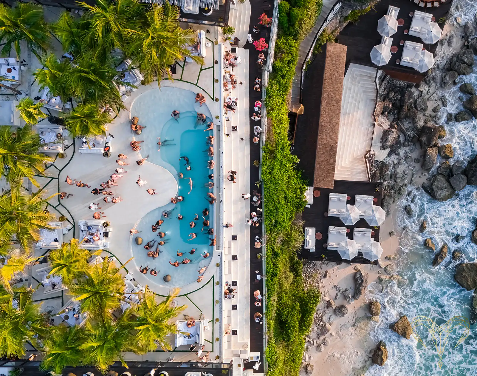 Overhead view of the El Kabron infinity pool, deck and cliff stairs descending to the rocks and Indian Ocean below