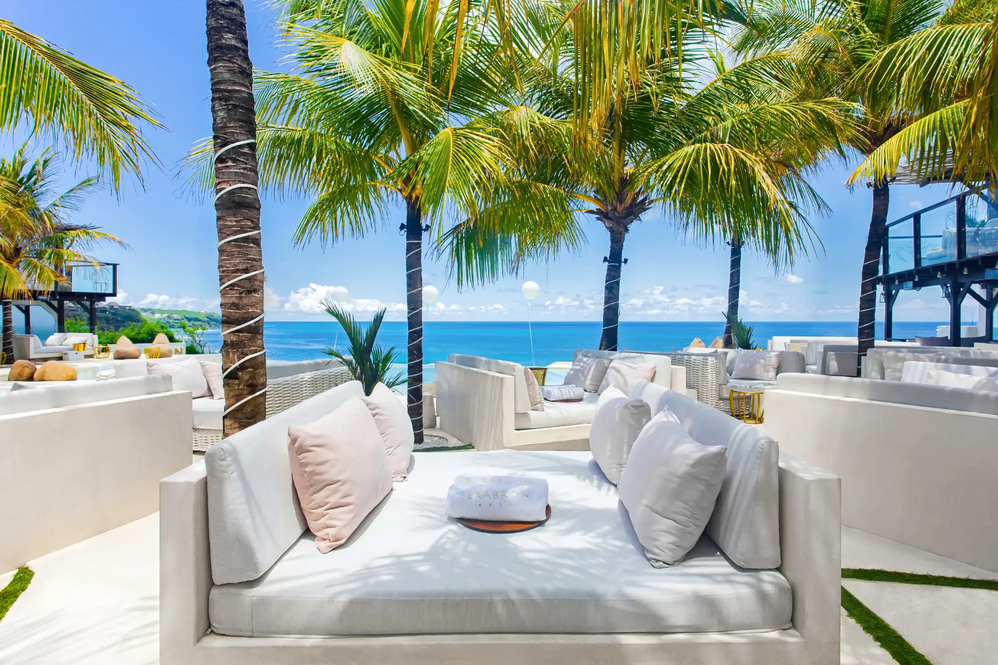 El Kabron Hedonism Lounge daybed under palm trees with white linen cushions facing the Indian Ocean