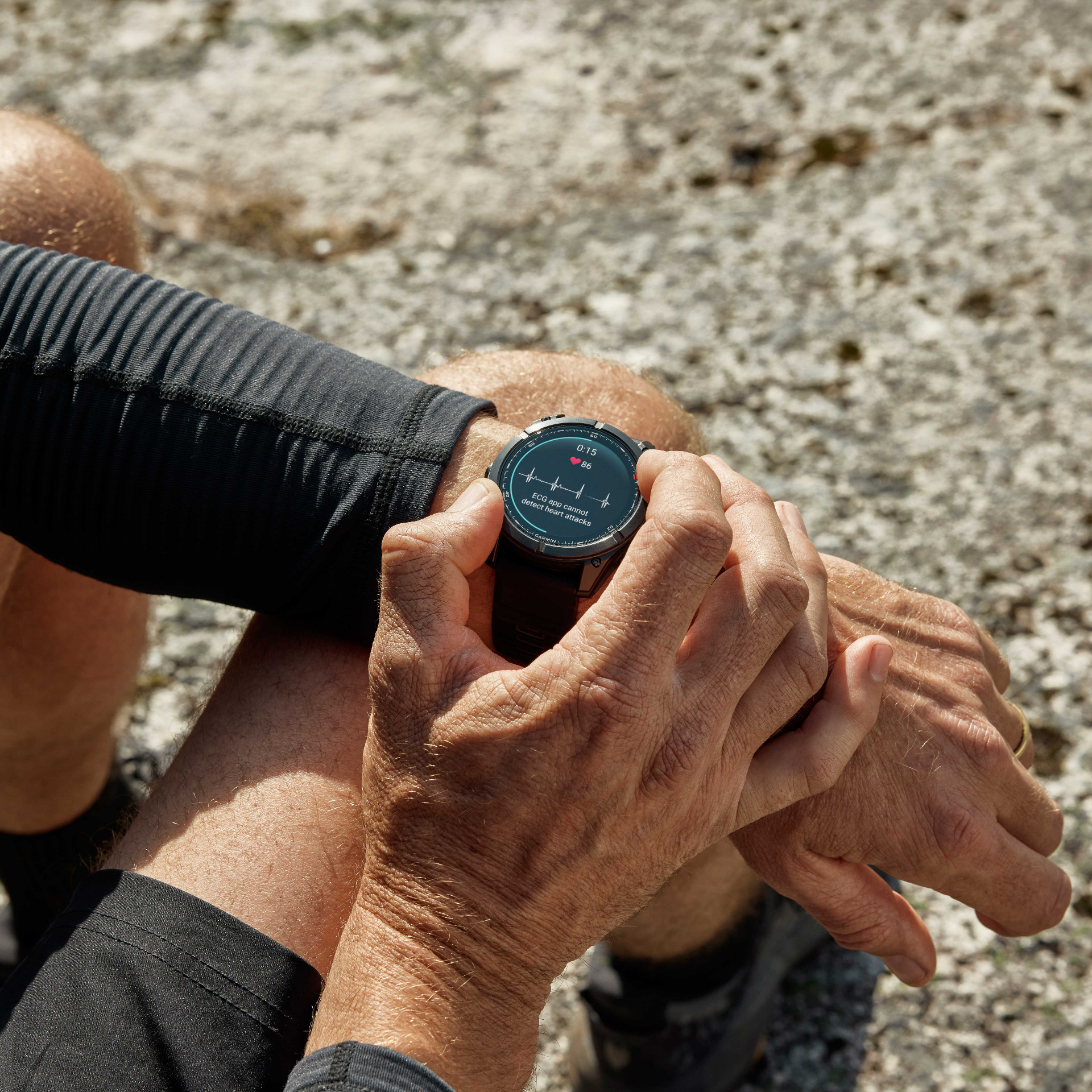 Garmin fēnix 8 Pro AMOLED worn on the wrist outdoors, displaying an ECG heart-rate graph