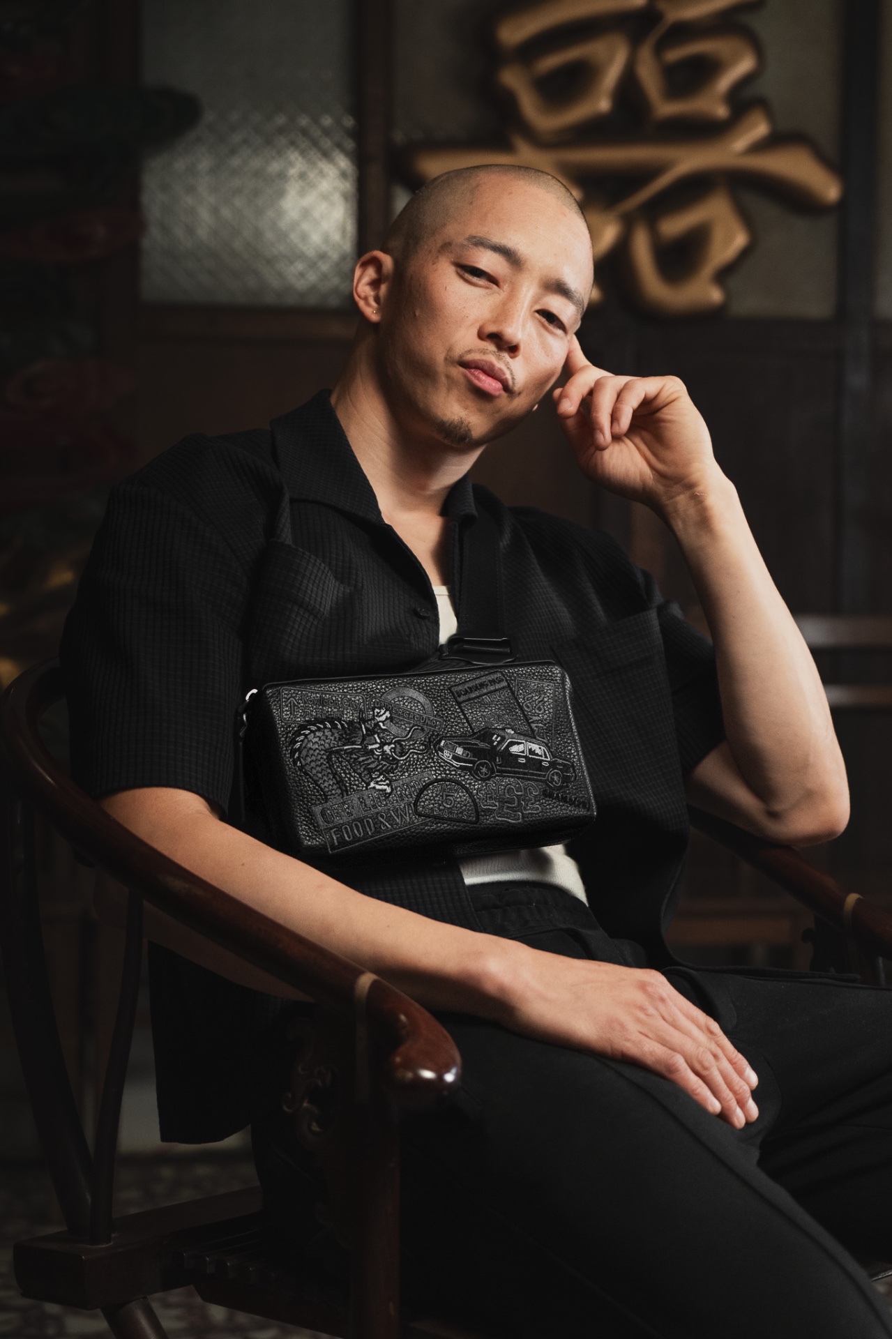 Benjamin Chan, founder of Grams28, wearing a cross-body bag with embossed leather detailing
