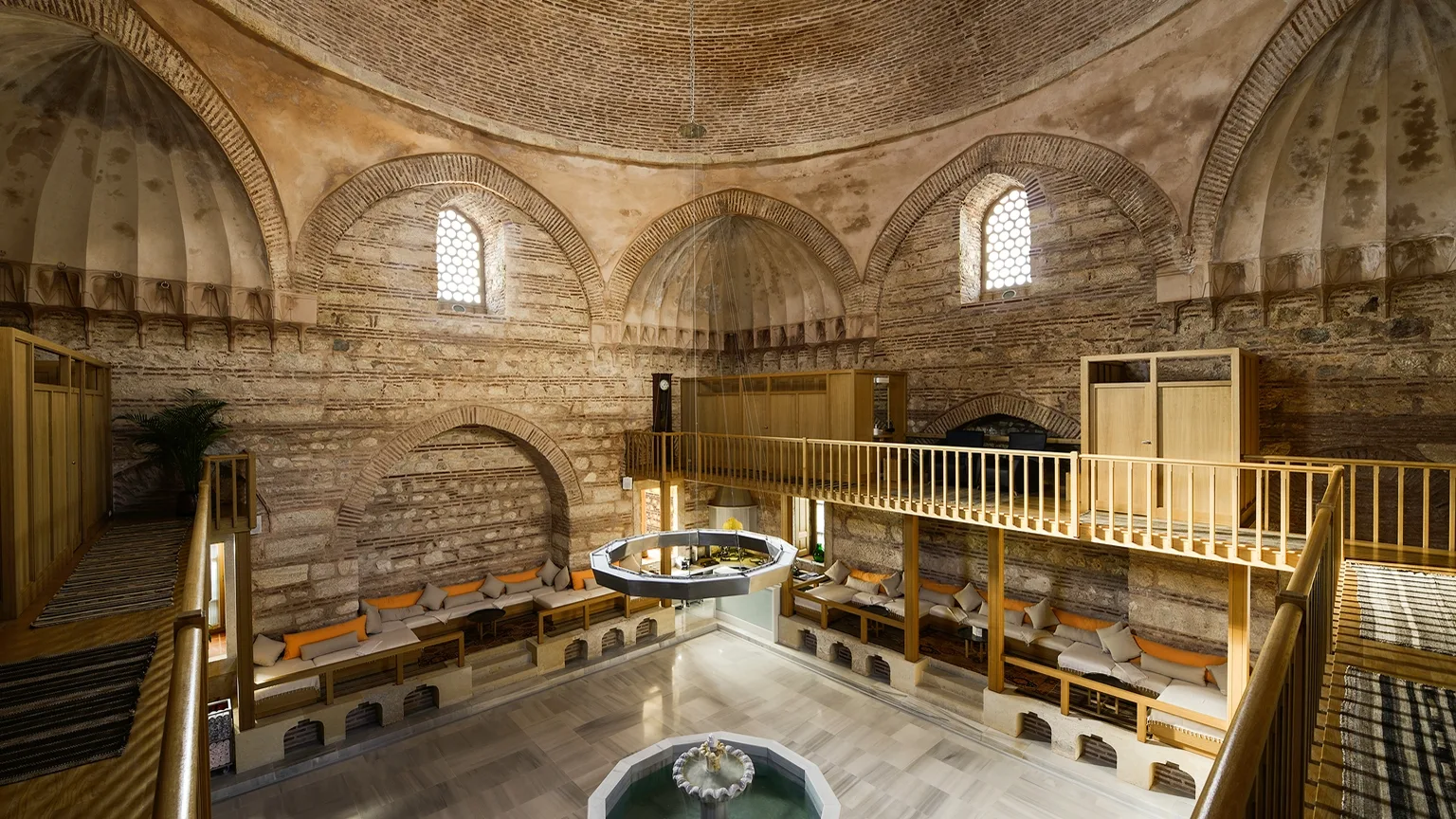 Kılıç Ali Paşa Hamamı — the upper timber gallery looking across the brick dome and the alcoves below
