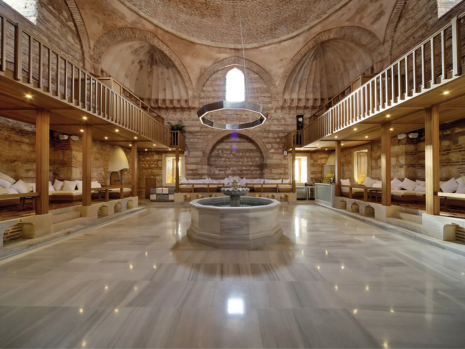 Kılıç Ali Paşa Hamamı, Istanbul — the restored domed camekân with its marble fountain, polished floor and timber galleries