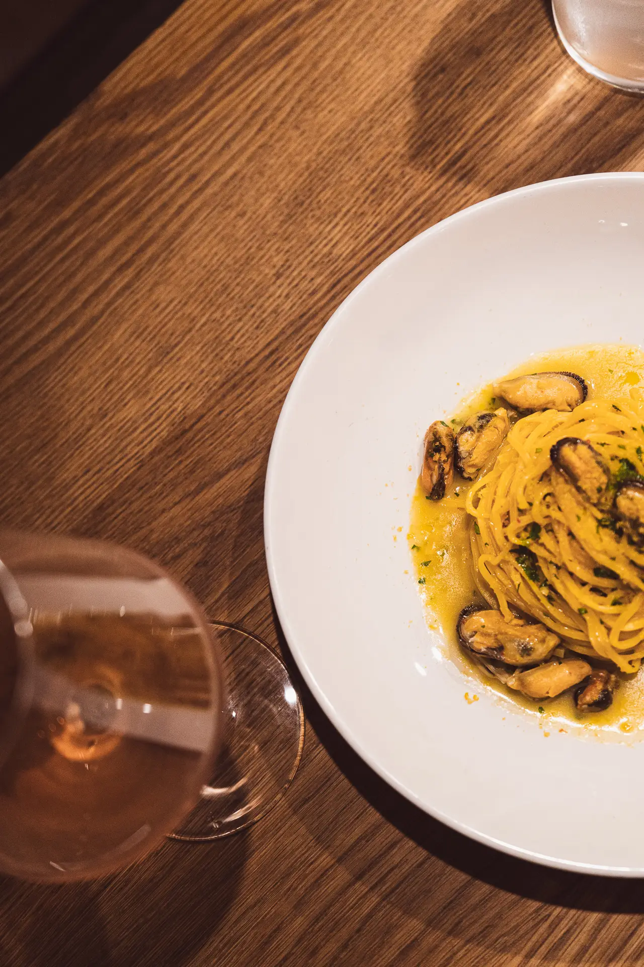 Pasta dish with a glass of wine at Luna Wine Bar