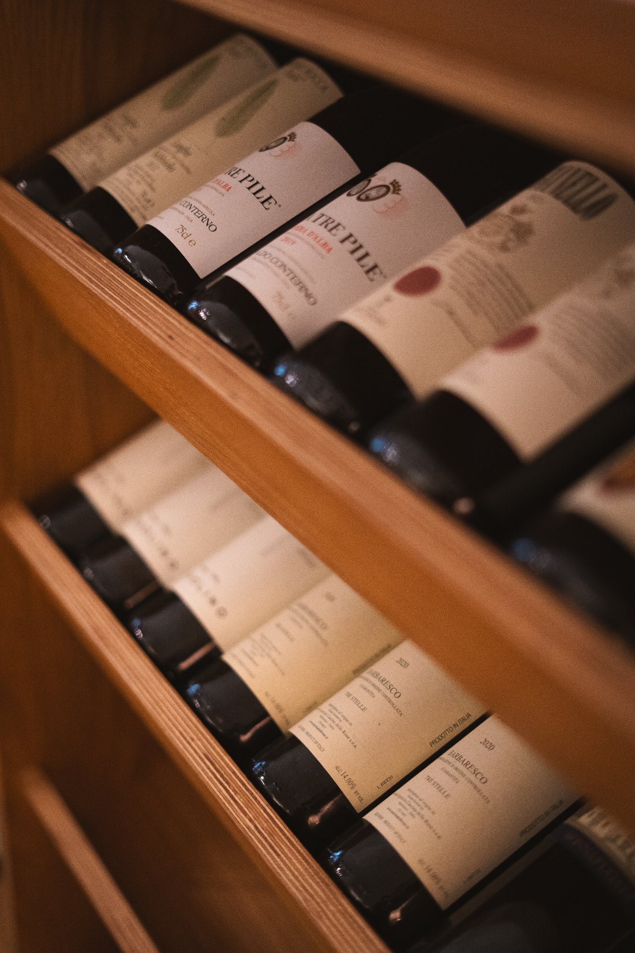Wine bottles on a wooden rack at Luna Wine Bar