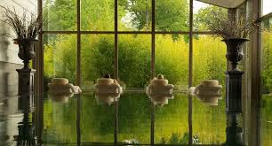 The hydrotherapy pool inside the thermal suite at Monart Destination Spa, looking out through tall windows onto the bamboo garden