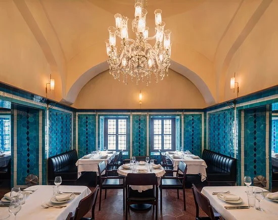 Pandeli's vaulted dining hall — turquoise tiled walls, black banquettes and a crystal chandelier under the domed ceiling