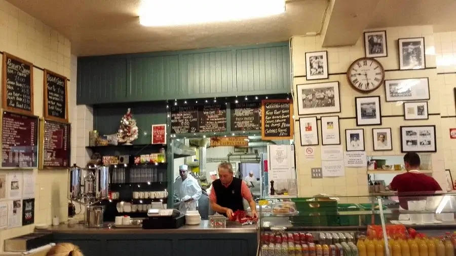 Regency Café — the counter and handwritten menu boards, cooks working behind the pass