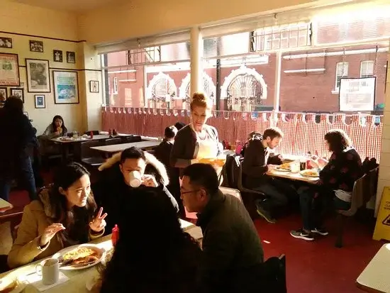 Regency Café — the dining room at breakfast, formica tables full under the front windows