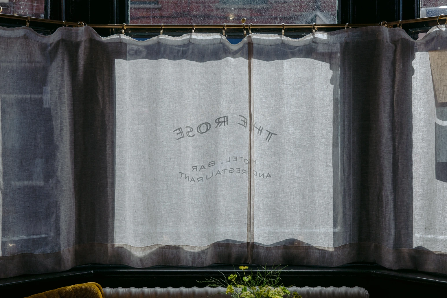 Window curtain with The Rose branding at The Rose, Deal