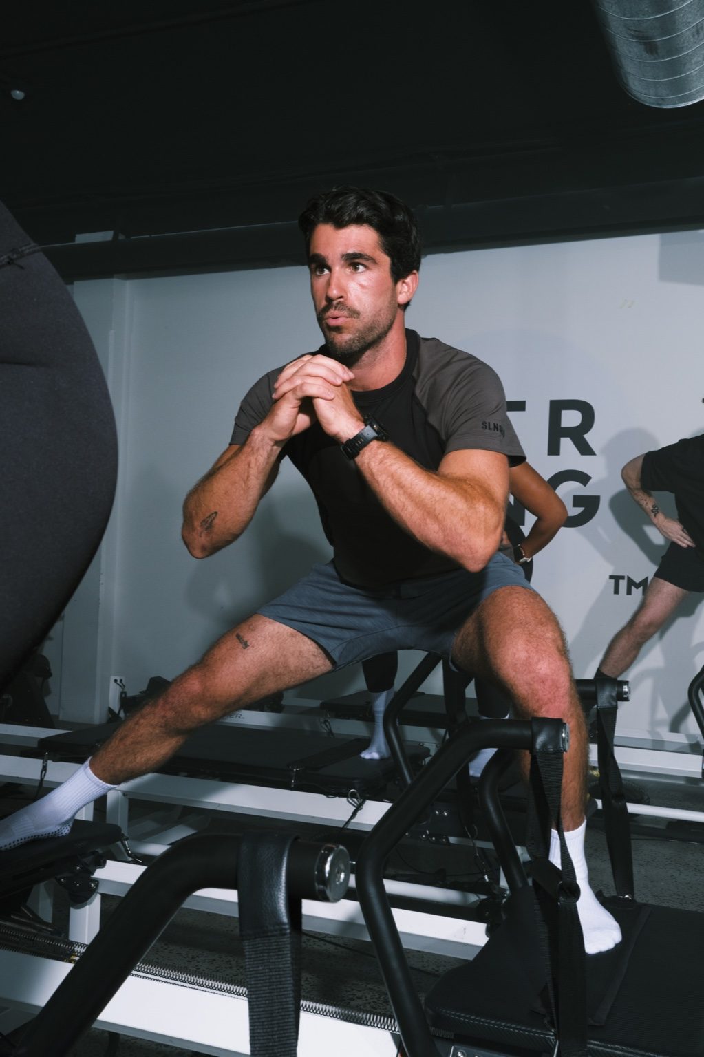 Concentrated reformer work during Strong Pilates class
