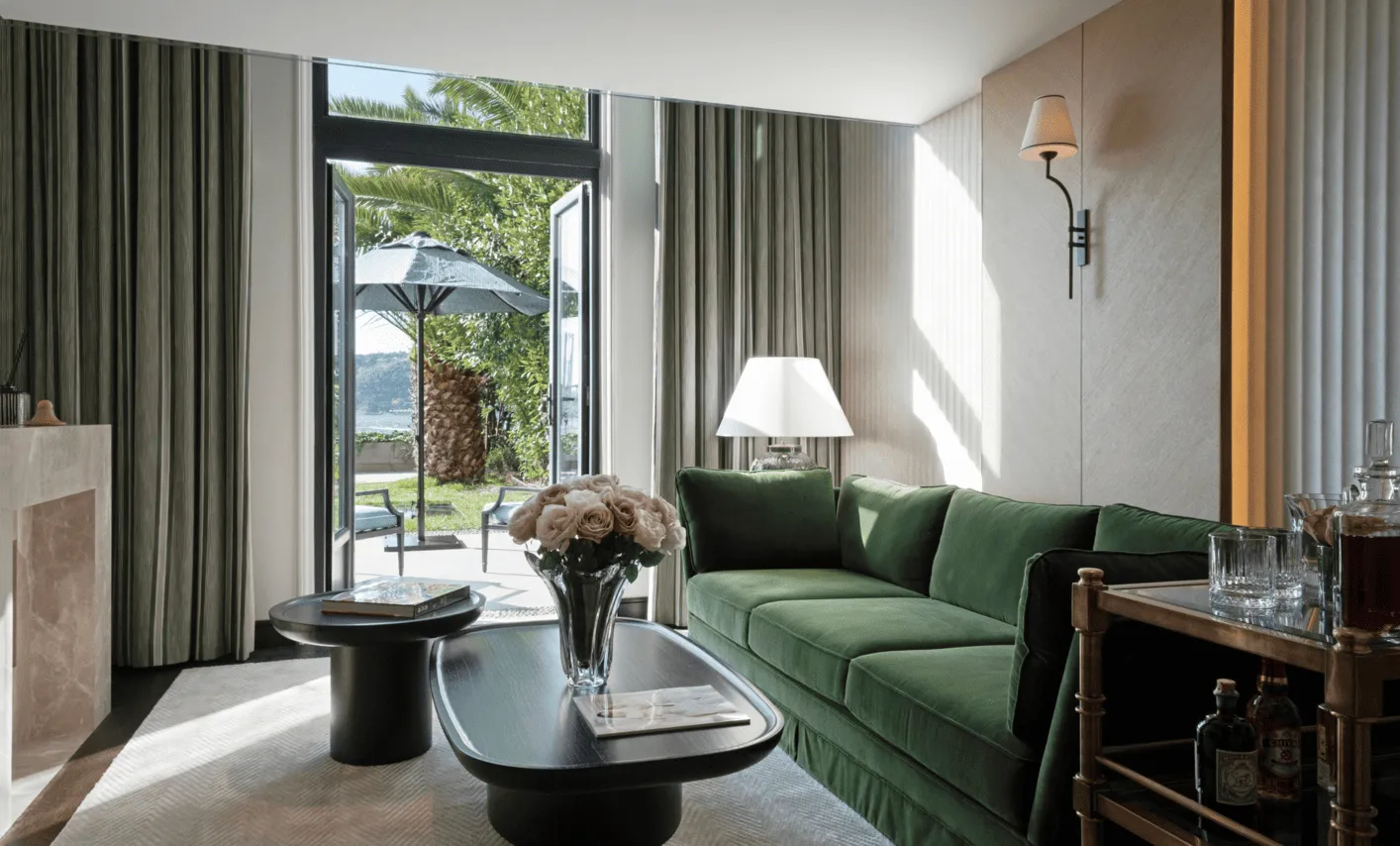 Vakko Hotel Sümahan Bosphorus — a suite with a green velvet sofa and doors opening onto the Bosphorus shore