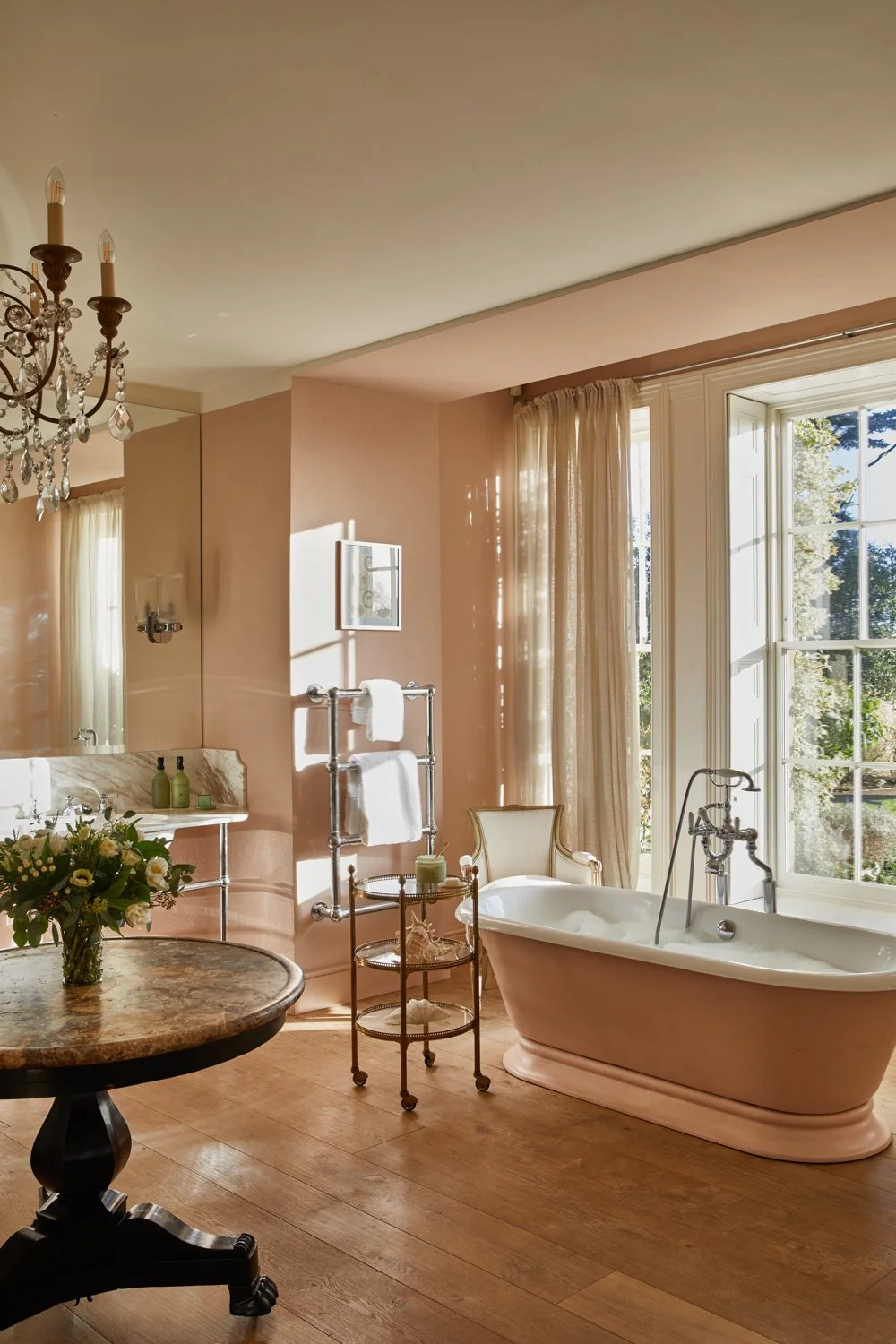 Thyme — guest bathroom interior with soft pink walls and freestanding bath