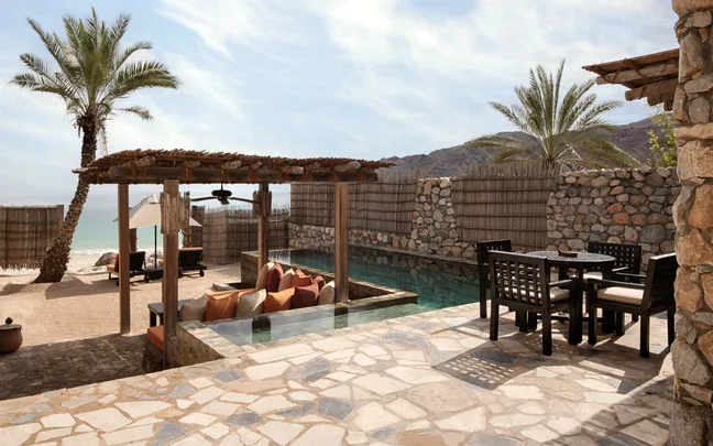 Six Senses Zighy Bay — beachfront pool villa terrace with private pool, pergola seating and the Gulf of Oman beyond