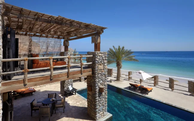 Six Senses Zighy Bay — Retreat villa balcony with private plunge pool overlooking the Gulf of Oman and a palm-fringed private beach