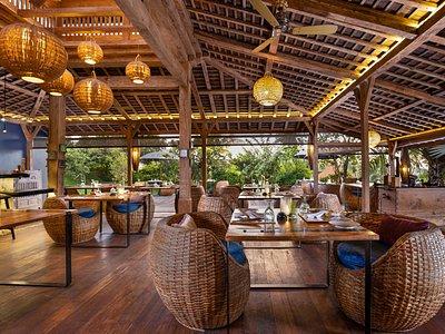 Ivy Café, Ubud — open-air pavilion with rattan chairs, hanging lanterns and timber roof above the dining tables
