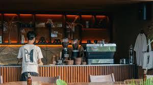 Two Face, Ubud — open-concept café bar with specialty coffee machine and warm interior lighting