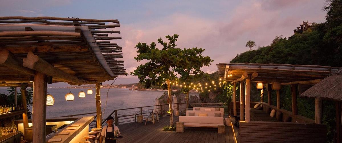 Ulu Cliffhouse — clifftop deck and bar above the Indian Ocean at dusk, Labuan Sait, Uluwatu