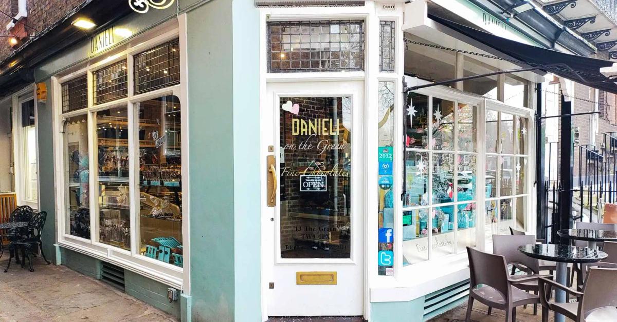 Danieli on the Green, Richmond — the pale-mint chocolate shop on the corner where Brewers Lane meets Richmond Green, with 'DANIELI on the Green — Fine Chocolates' lettered on the glass door and a small pavement café to one side