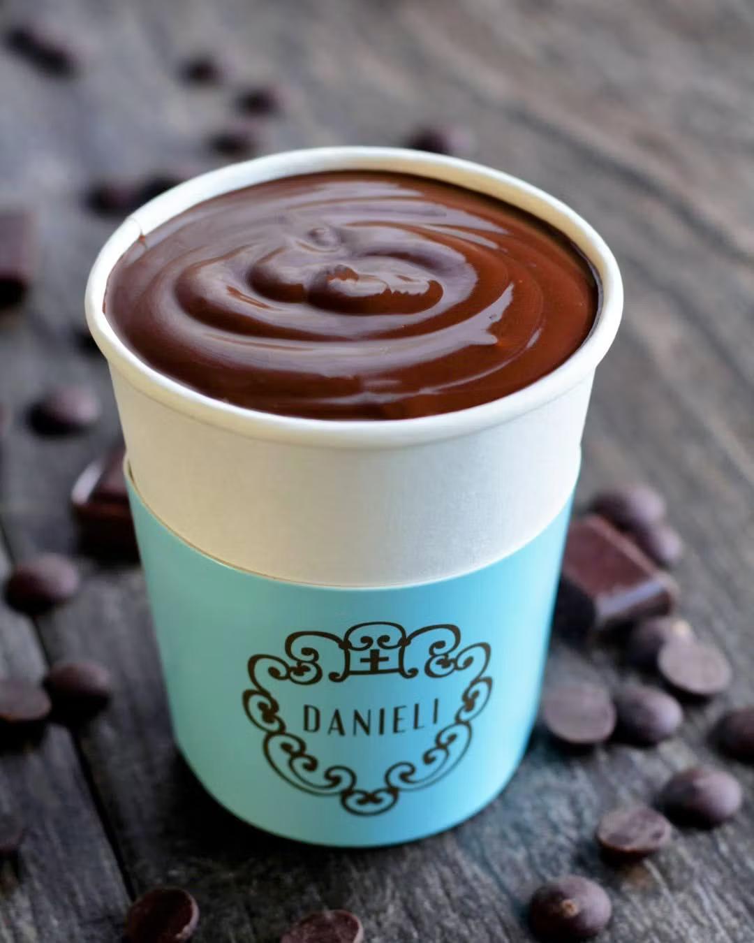 Danieli's viral thick hot chocolate — a small glass cup of deep, glossy dark chocolate so thick a spoon stands almost upright in it