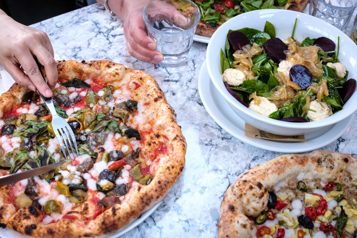 Santa Maria — Neapolitan pizzas and salad on a marble table, Fitzrovia